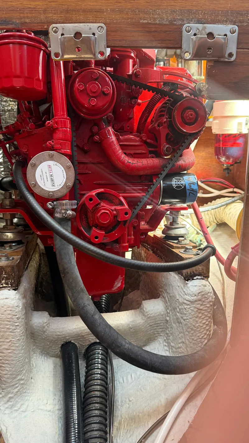 Slide: The Image of Red engine inside a 1981 Sabre 28 sailboat, showcasing detailed mechanical components. - 23