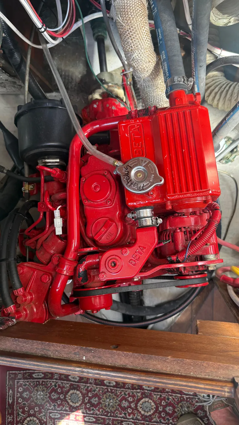 Slide: The Image of Red engine in a 1981 Sabre 28 sailboat, showcasing detailed mechanical components. - 25