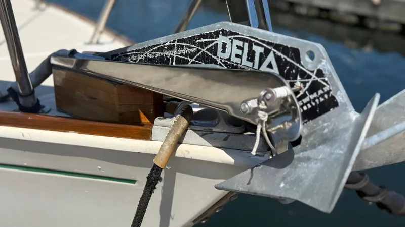 Slide: The Image of Anchor on 1981 Sabre 28 sailboat with Delta branding, docked by the water. - 27