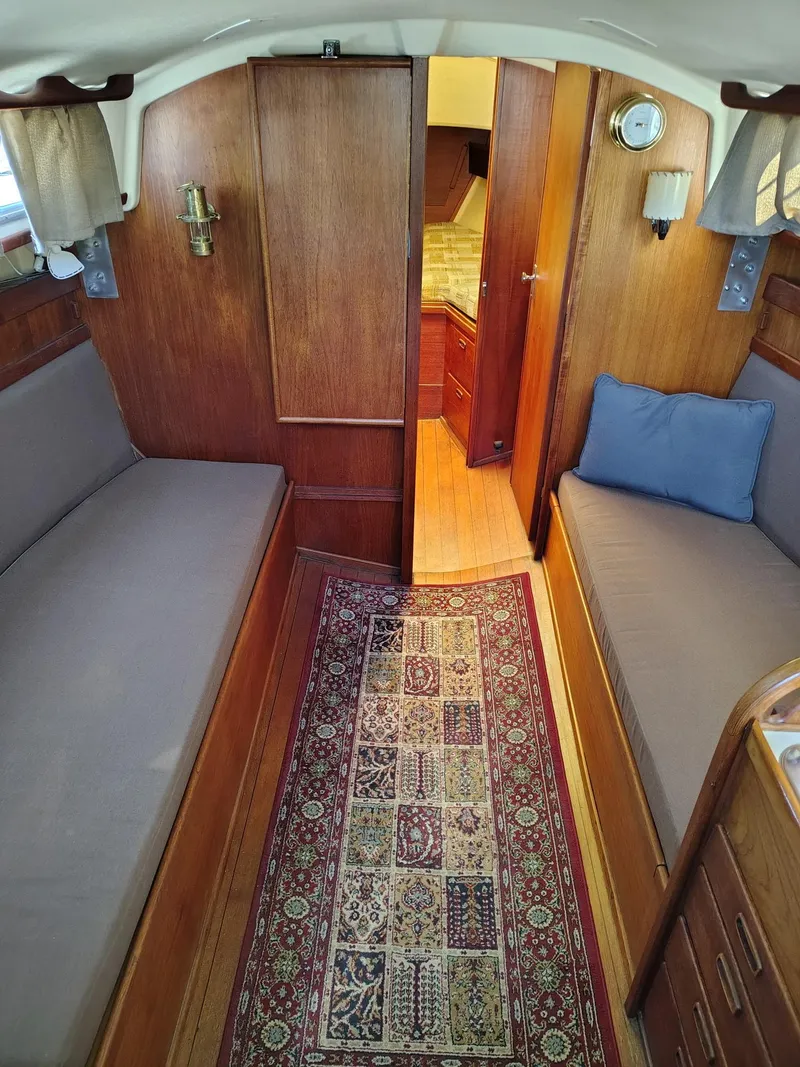 Slide: The Image of Interior of a 1981 Sabre 28 sailboat with wooden paneling and cozy seating. - 3
