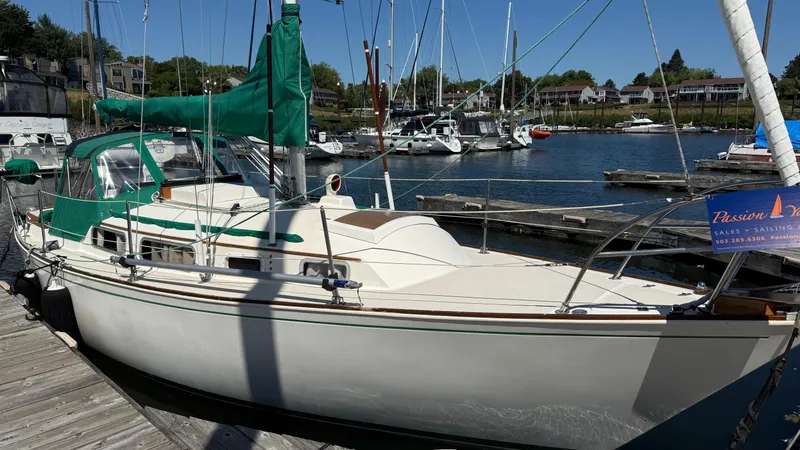Slide: The Image of 1981 Sabre 28 sailboat docked at marina with green sail cover. - 32