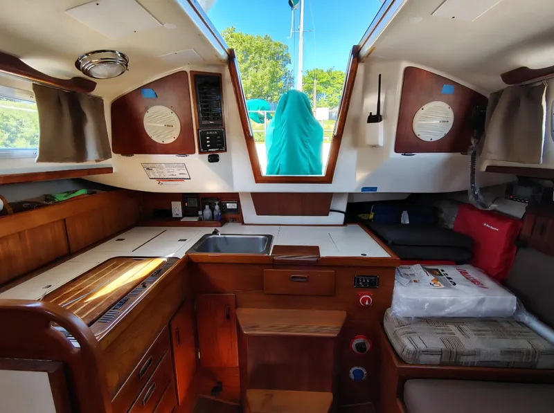 Slide: The Image of Interior of a 1981 Sabre 28 sailboat featuring a compact kitchen and seating area. - 4