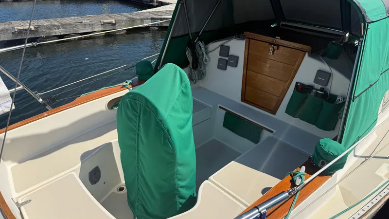 Slide: The Image of 1981 Sabre 28 sailboat cockpit with green covers, docked at marina. - 42