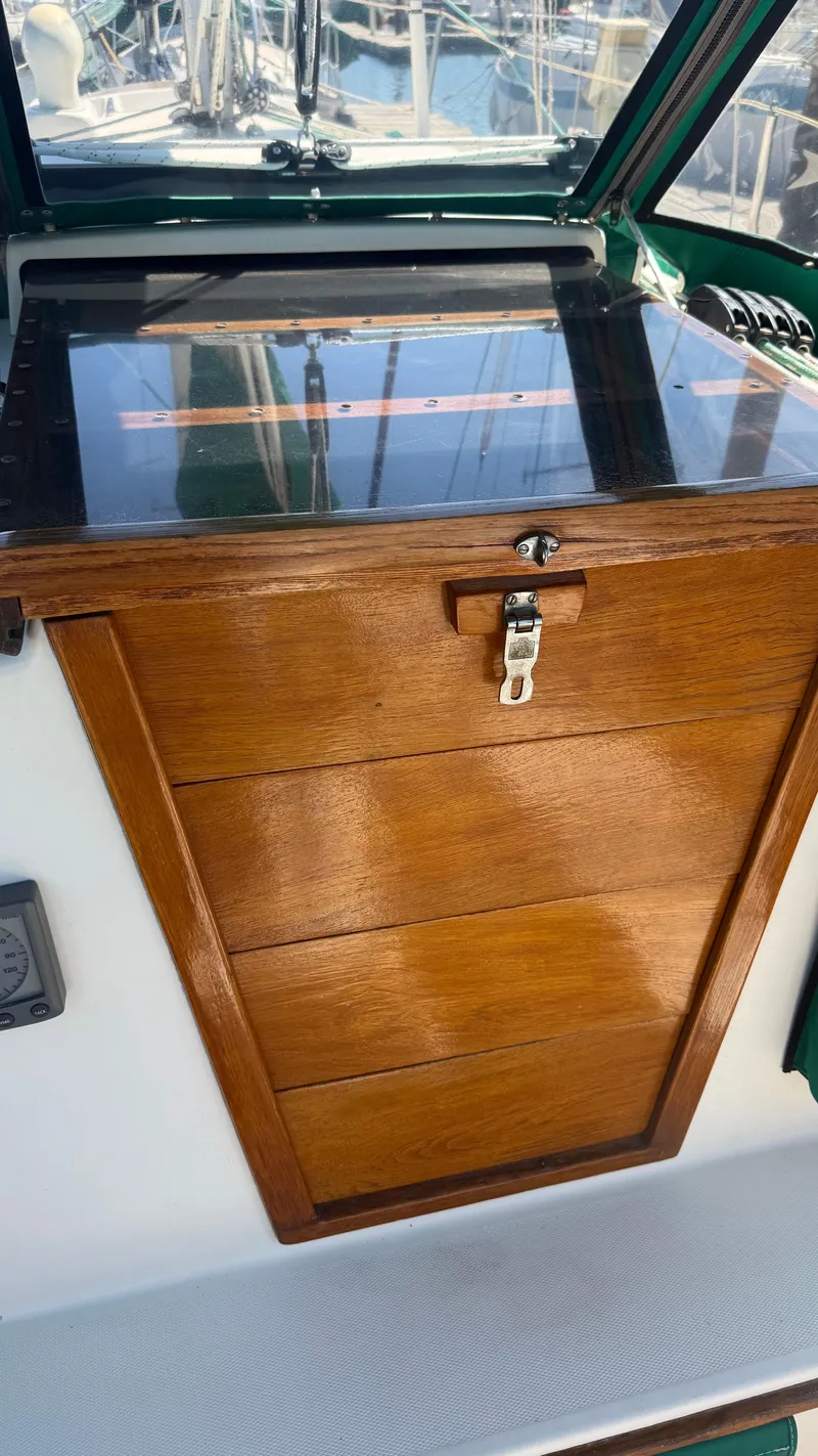 Slide: The Image of 1981 Sabre 28 sailboat cockpit with wooden hatch and lock. - 47