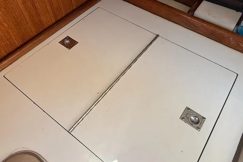 Slide: The Image of Hinged storage compartment on 1981 Sabre 28 sailboat interior, featuring wooden trim. - 8