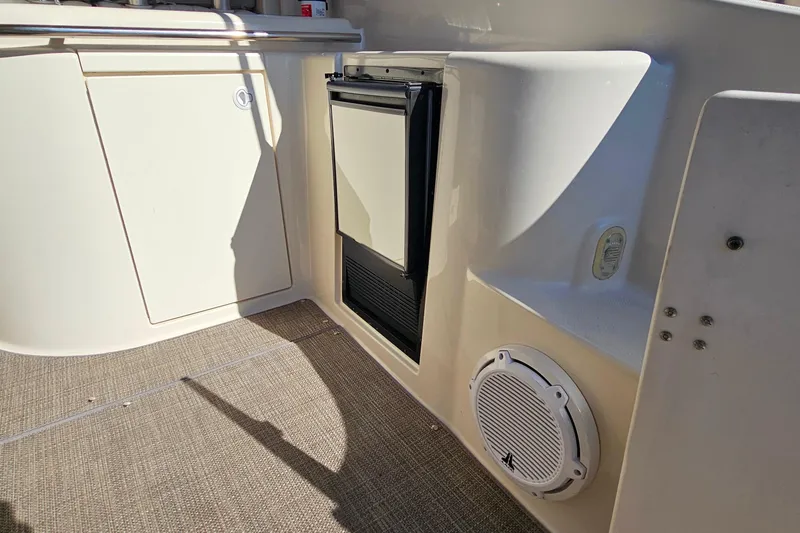 Slide: The Image of 2001 Maxum 3500 SCR boat interior with mini fridge and speaker. - 10