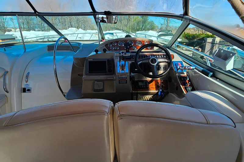 Slide: The Image of Cockpit of 2001 Maxum 3500 SCR boat with steering wheel and control panel. - 12