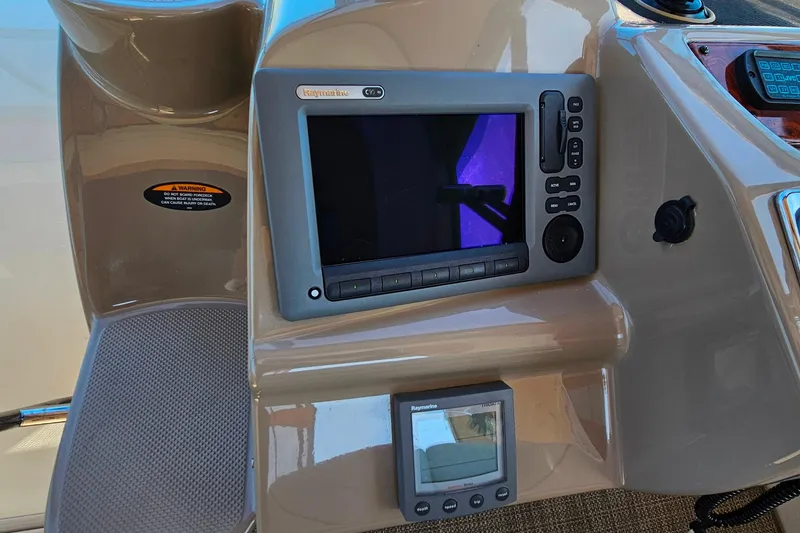 Slide: The Image of 2001 Maxum 3500 SCR dashboard with Raymarine navigation system and controls. - 15