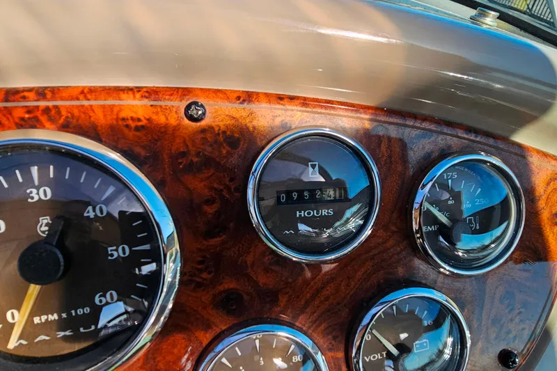 Slide: The Image of Dashboard of a 2001 Maxum 3500 SCR boat with gauges and wood finish. - 16