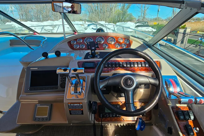 Slide: The Image of Helm of 2001 Maxum 3500 SCR boat with steering wheel and control panel. - 18