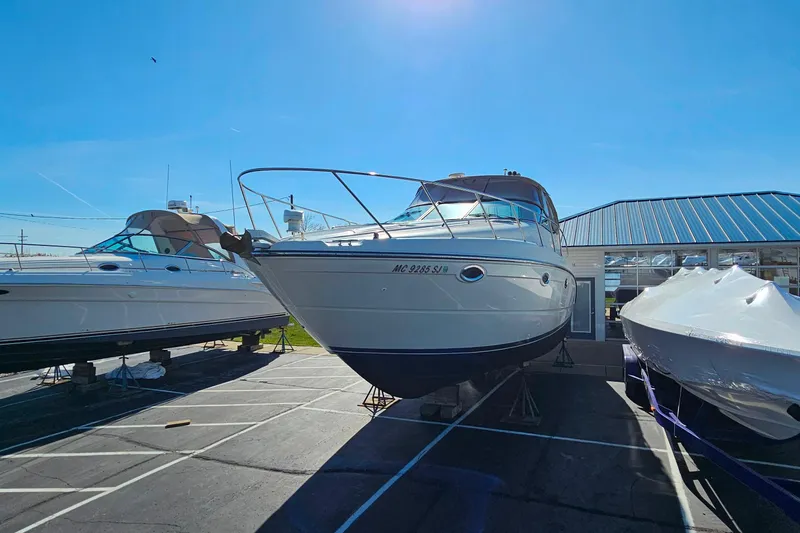 Slide: The Image of 2001 Maxum 3500 SCR boat on display in a marina under clear blue skies. - 2