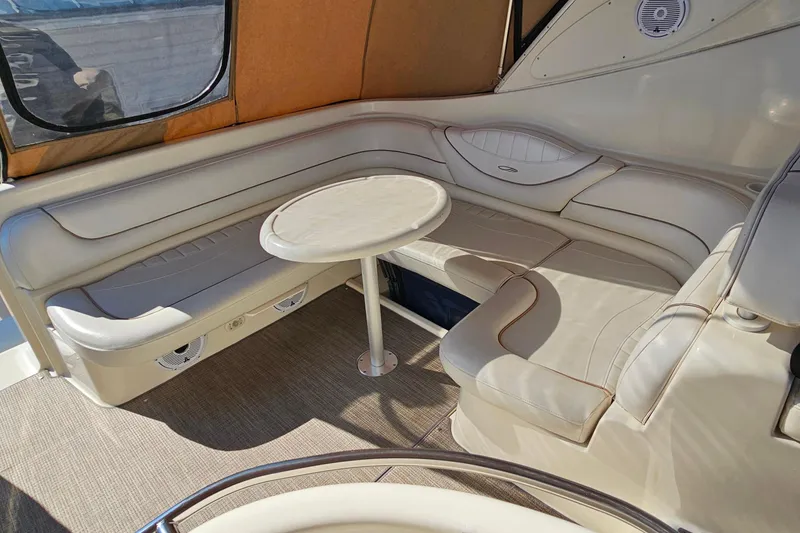 Slide: The Image of 2001 Maxum 3500 SCR yacht interior with beige seating and round table. - 20