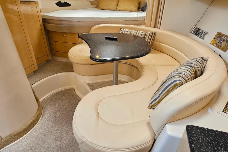 Slide: The Image of Luxurious interior of 2001 Maxum 3500 SCR yacht with curved seating and elegant decor. - 24