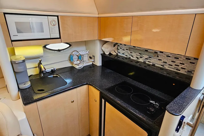 Slide: The Image of 2001 Maxum 3500 SCR yacht kitchen with modern appliances and sleek countertops. - 27