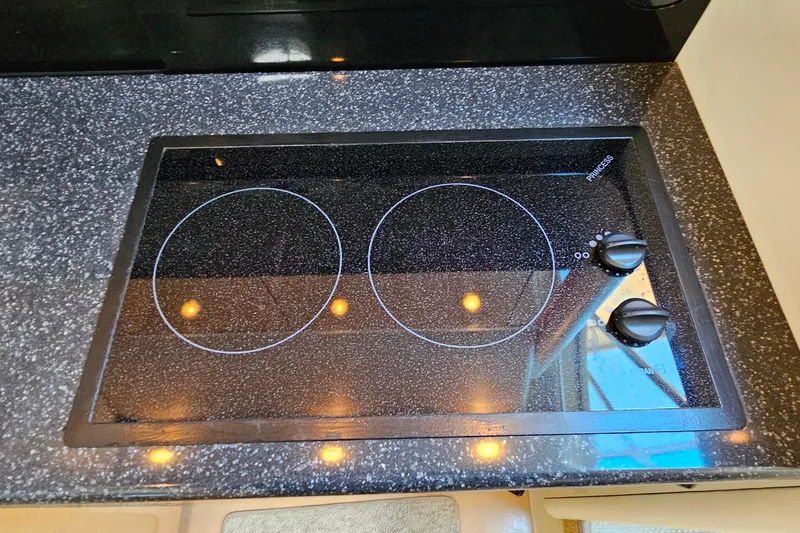 Slide: The Image of Stovetop in 2001 Maxum 3500 SCR yacht kitchen, featuring dual burners and sleek design. - 30