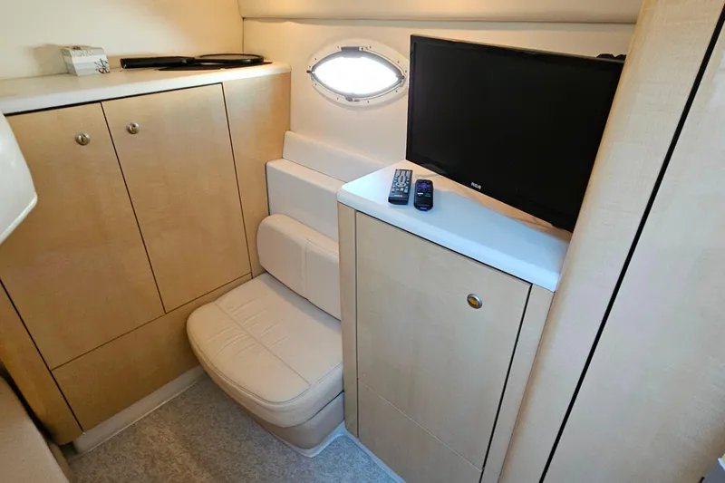 Slide: The Image of Interior of 2001 Maxum 3500 SCR yacht with TV, seating, and storage cabinets. - 33