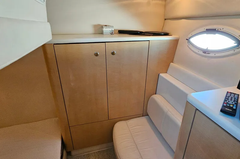 Slide: The Image of 2001 Maxum 3500 SCR cabin interior with wooden cabinets and seating. - 34