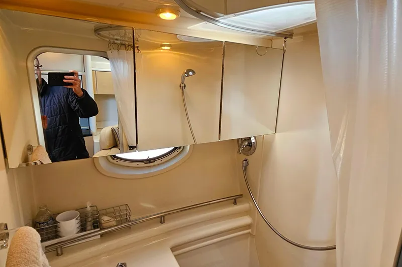 Slide: The Image of 2001 Maxum 3500 SCR yacht bathroom with shower, mirror, and porthole window. - 38