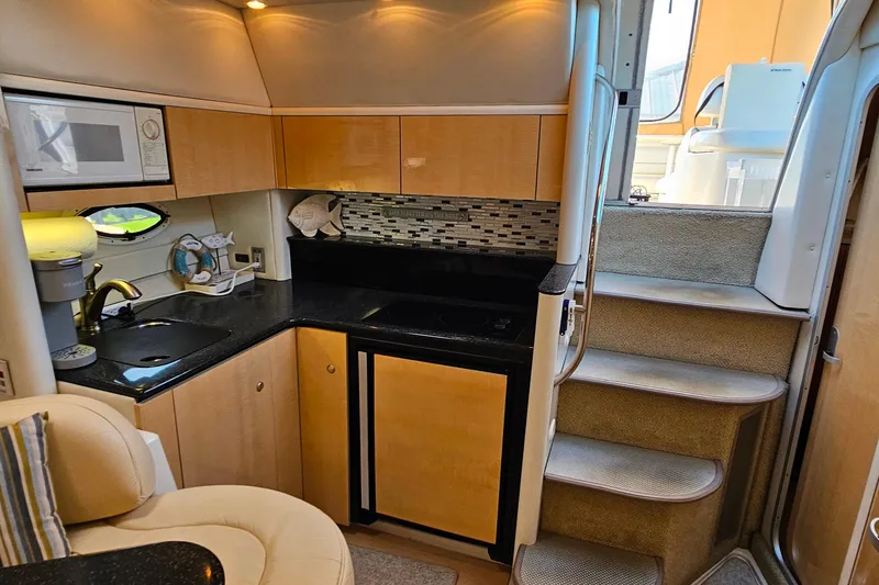 Slide: The Image of 2001 Maxum 3500 SCR yacht interior with kitchenette and stairs. - 39