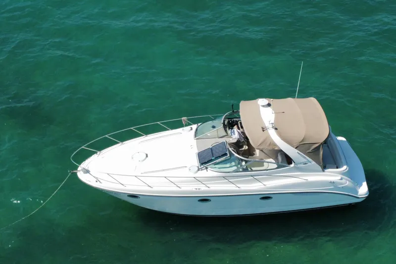 Slide: The Image of 2001 Maxum 3500 SCR yacht anchored on clear turquoise water. - 41