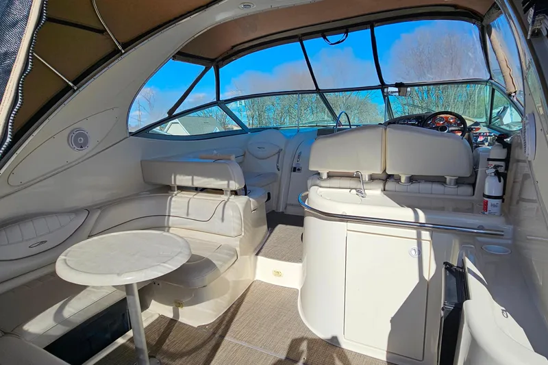 Slide: The Image of Interior of 2001 Maxum 3500 SCR boat with seating and helm, under clear blue sky. - 8