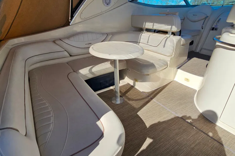 Slide: The Image of 2001 Maxum 3500 SCR yacht interior with beige seating and round table. - 9