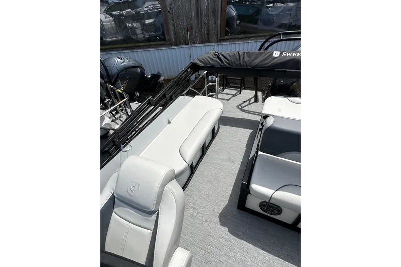 Slide: The Image of 2026 Godfrey Sweetwater 2286 SFLC boat interior with white seating and modern design. - 11