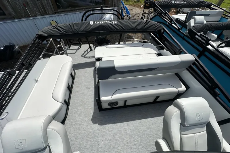 Slide: The Image of 2026 Godfrey Sweetwater 2286 SFLC pontoon boat interior with plush seating and modern design. - 18
