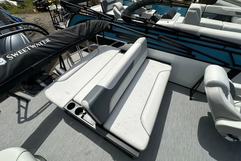 Slide: The Image of 2026 Godfrey Sweetwater 2286 SFLC boat interior with white seating and cup holders. - 20