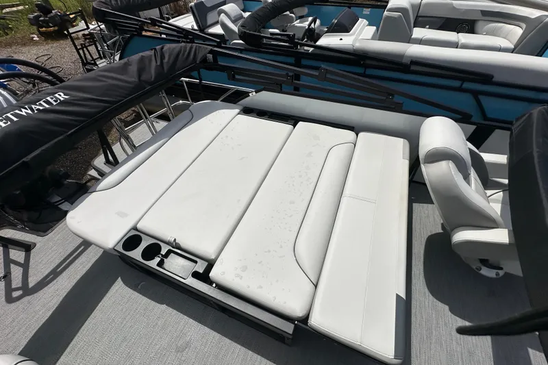Slide: The Image of 2026 Godfrey Sweetwater 2286 SFLC boat interior with white seating and cup holders. - 21