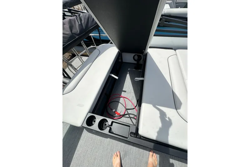 Slide: The Image of Open storage compartment on 2026 Godfrey Sweetwater 2286 SFLC boat, featuring seating and cup holders. - 22