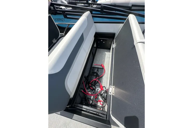 Slide: The Image of Open storage compartment on 2026 Godfrey Sweetwater 2286 SFLC boat, showing wiring and seating. - 24