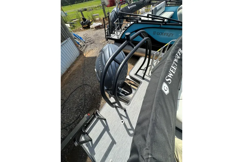 Slide: The Image of 2026 Godfrey Sweetwater 2286 SFLC pontoon boat with covered engine and deck. - 26