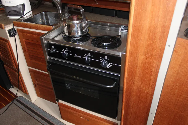 Slide: The Image of Compact kitchen in 2011 Ranger Tugs R-27 with stove, oven, and sink. - 13