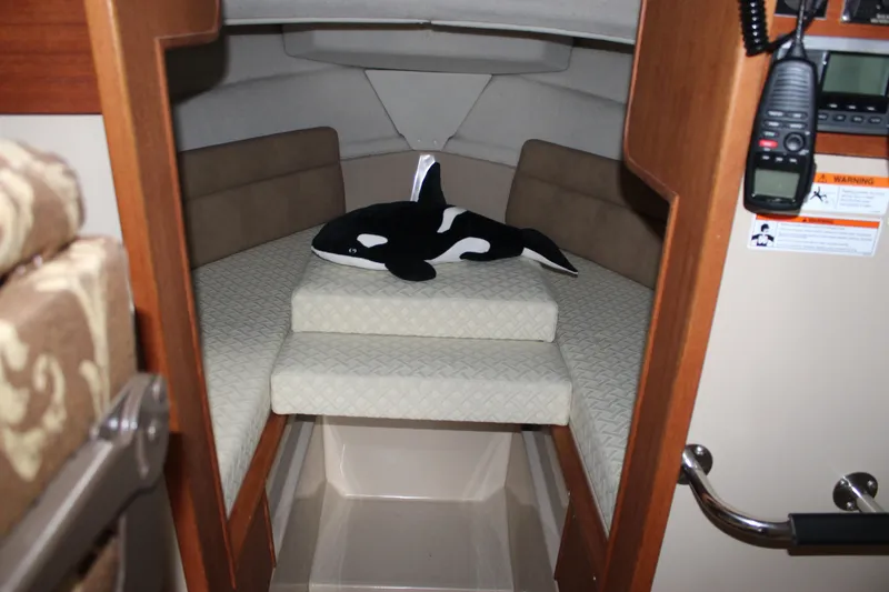 Slide: The Image of Cozy cabin interior of 2011 Ranger Tugs R-27 with plush orca toy on bed. - 17