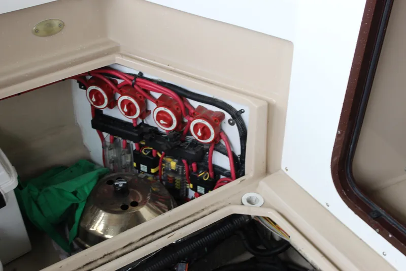 Slide: The Image of Electrical panel in 2011 Ranger Tugs R-27 boat, featuring red switches and wiring. - 22