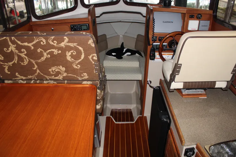 Slide: The Image of Interior of 2011 Ranger Tugs R-27 boat with wood accents and navigation equipment. - 33