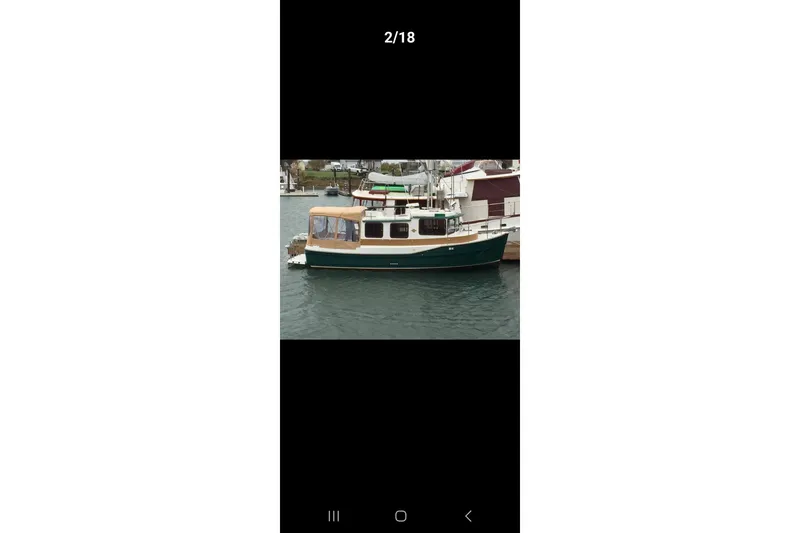 Slide: The Image of 2011 Ranger Tugs R-27 boat docked in a marina. - 36
