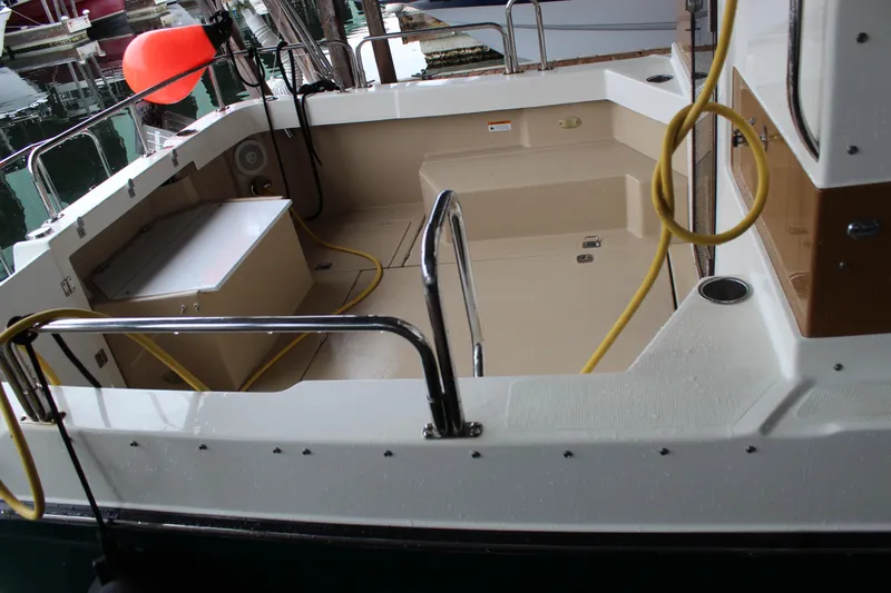 Slide: The Image of 2011 Ranger Tugs R-27 boat deck with railing and docked at marina. - 6