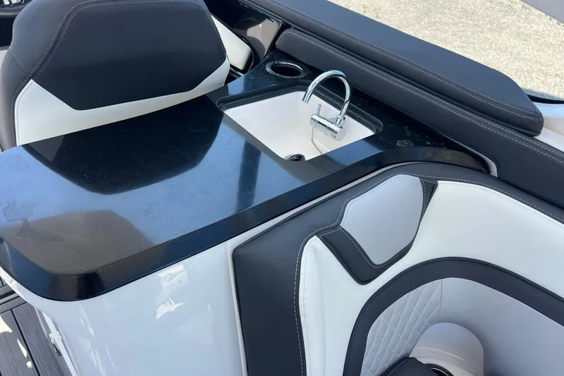 Slide: The Image of Interior of 2022 Yamaha 275 SD boat featuring a sleek sink and seating area. - 10