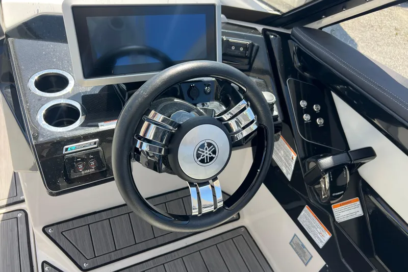 Slide: The Image of Steering wheel and dashboard of 2022 Yamaha 275 SD boat with touchscreen display. - 11