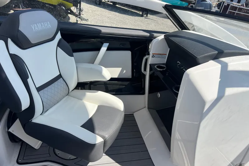 Slide: The Image of Interior of 2022 Yamaha 275 SD boat featuring a sleek captain's chair and dashboard. - 12