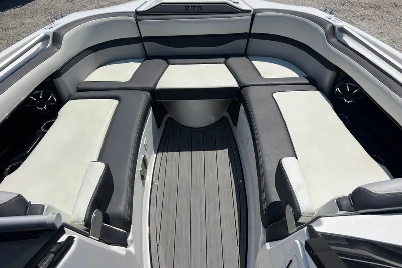 Slide: The Image of 2022 Yamaha 275 SD boat interior with cushioned seating and sleek design. - 13