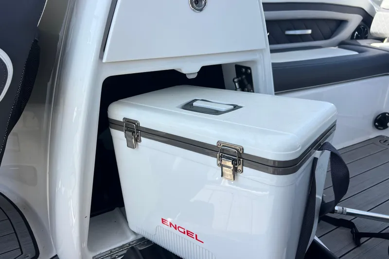 Slide: The Image of 2022 Yamaha 275 SD boat interior with Engel cooler in storage compartment. - 15