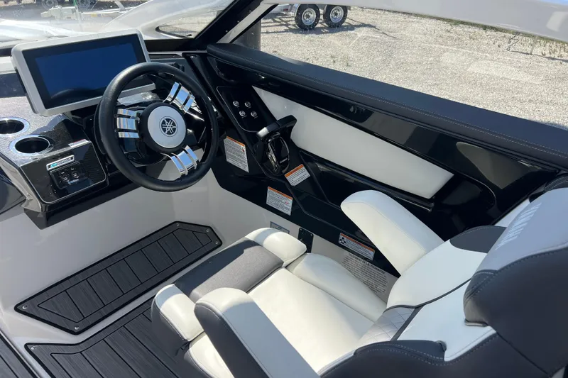 Slide: The Image of 2022 Yamaha 275 SD boat interior with modern steering and dashboard controls. - 9