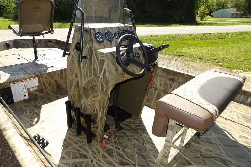 Slide: The Image of 2026 Crestliner 1860 Retriever CC boat with camo design and central console. - 10