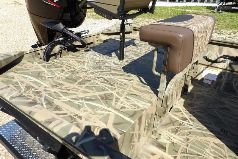 Slide: The Image of 2026 Crestliner 1860 Retriever CC boat interior with camouflage design and seating. - 13