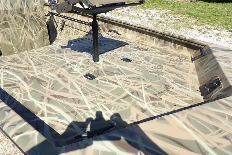 Slide: The Image of 2026 Crestliner 1860 Retriever CC boat with camouflage pattern, featuring a spacious deck. - 15