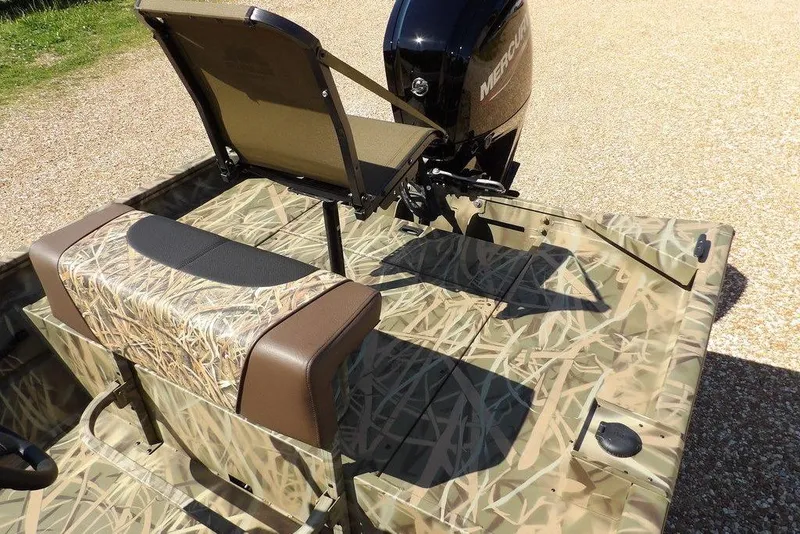 Slide: The Image of 2026 Crestliner 1860 Retriever CC boat with camouflage seating and Mercury outboard motor. - 16