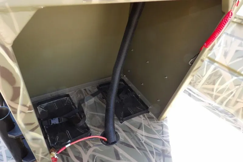 Slide: The Image of Interior view of 2026 Crestliner 1860 Retriever CC boat, showcasing wiring and storage compartments. - 17